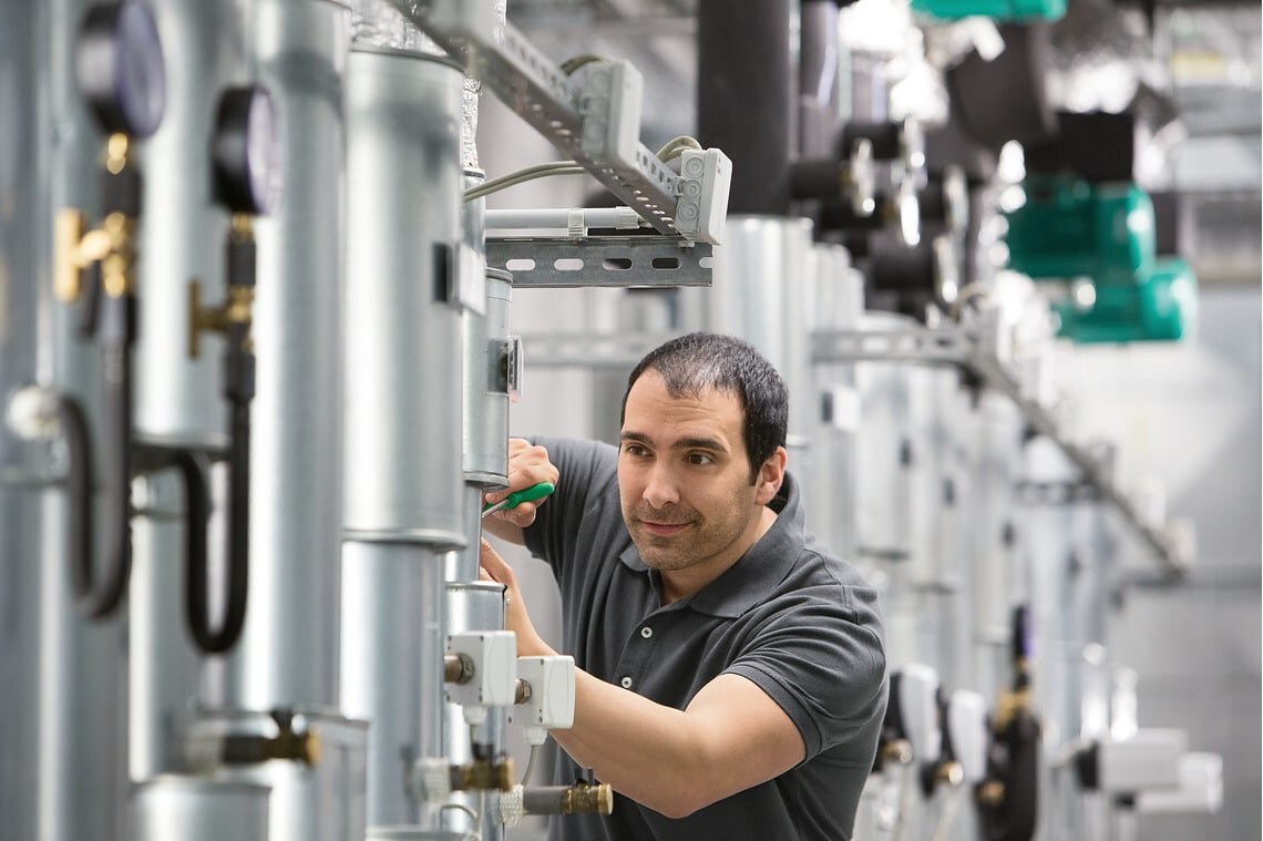Installer Jesus working in boiler room