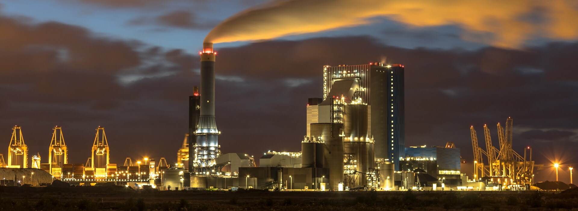 Industrial landscape with illuminated clouds at night in Europoort, Maasvlakte Rotterdam