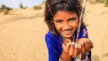A girl in a dry area rejoicing over access to clean water. a-girl-in-a-dry-area-rejoicing-over-access-to-clean-water