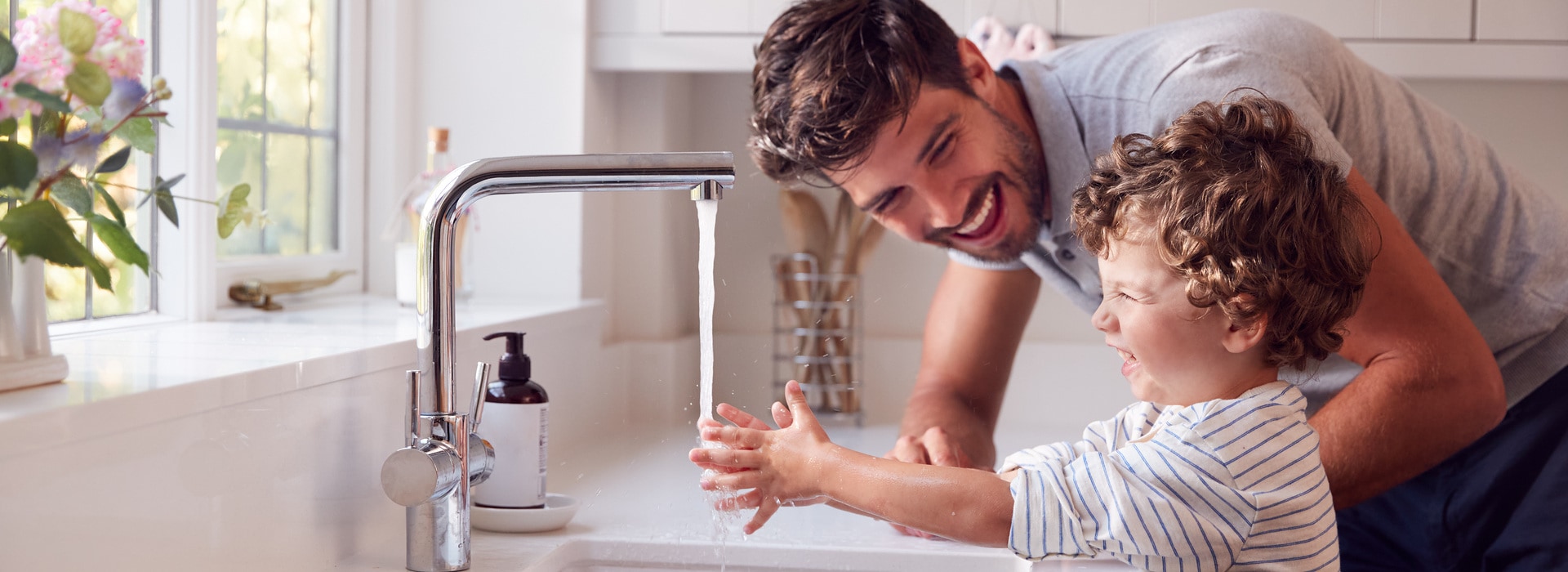 A father washing hands with his child a-father-washing-hands-with-his-child