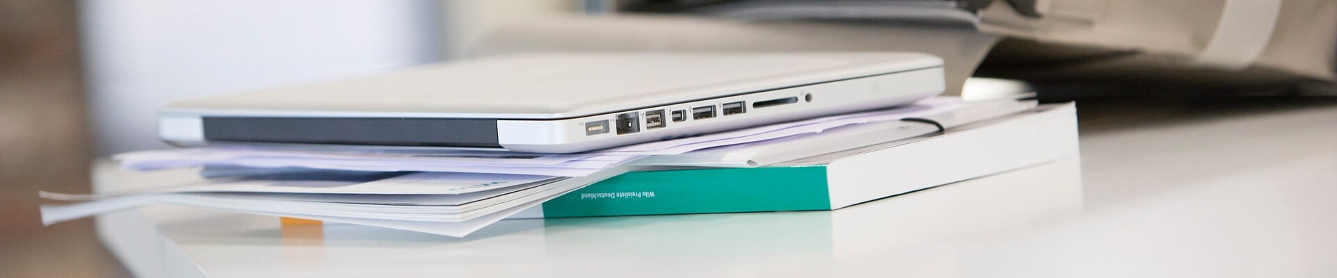 Office Desk with bag, notebook and some brochures