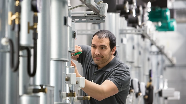 Installer Jesus working in boiler room