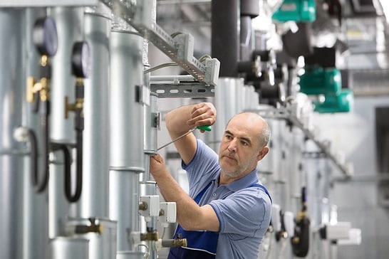 Installer Kalle working in boiler room