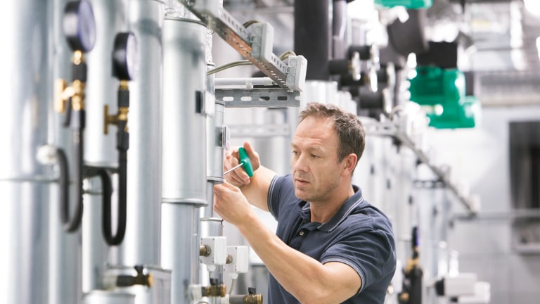 Installer Sascha working in boiler room