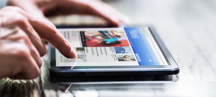 Reading Newspaper Article Online On Digital Tablet