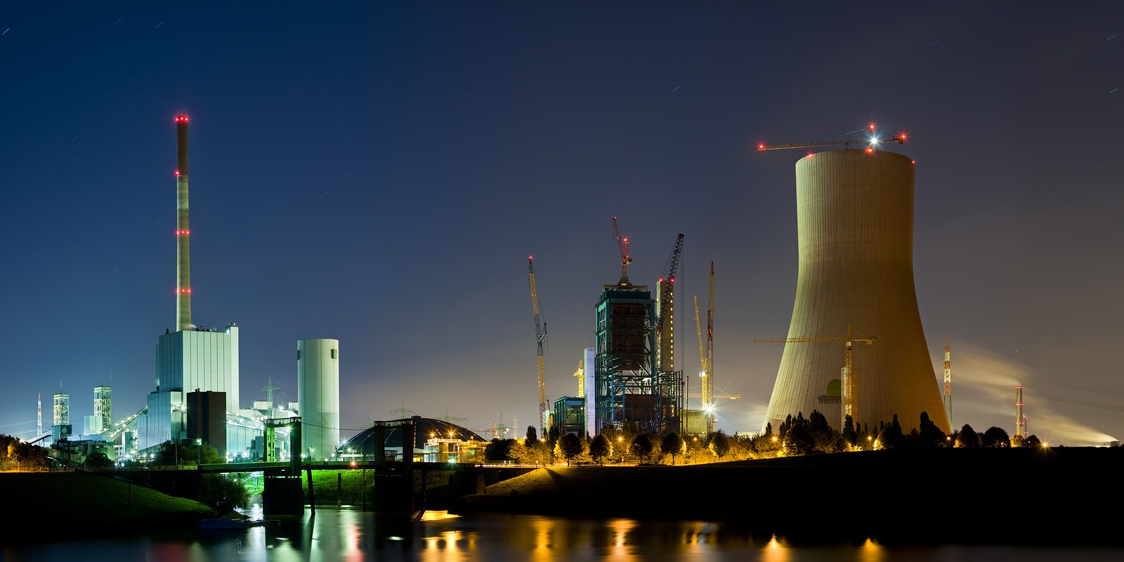 Panoramic night shot of an old coal power station and a new one under construction at night. Duisburg, Germany.