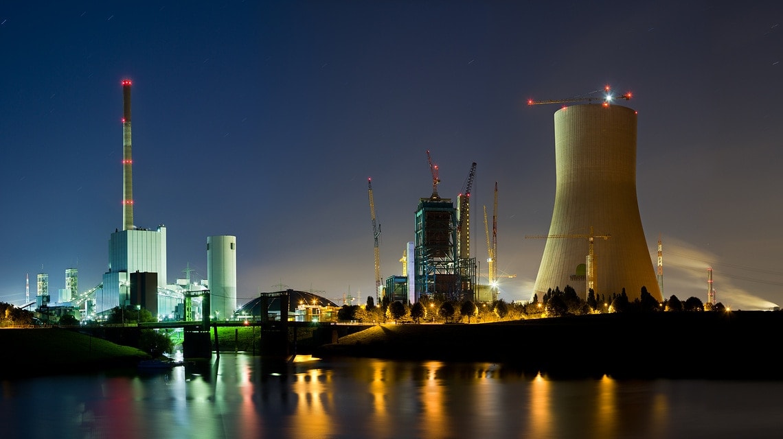 Panoramic night shot of an old coal power station and a new one under construction at night. Duisburg, Germany.
