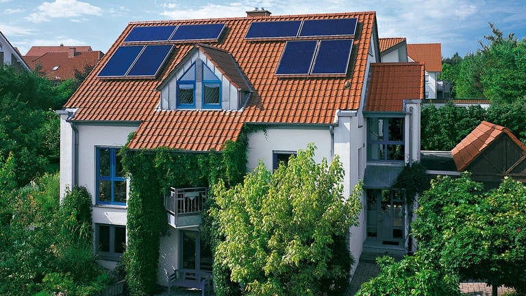 Multi family house with solar panels on the roof for solar heating
