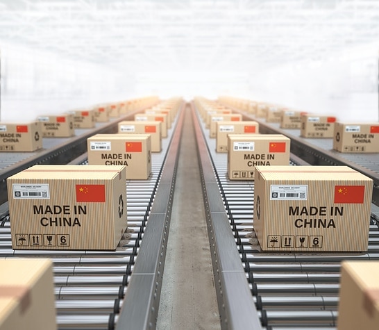 Made in China. Cardboard boxes with text made in China and chinese flag on the roller conveyor. 3d illustration