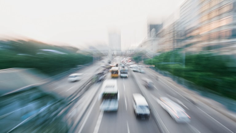 Blurred cars and busses on a street