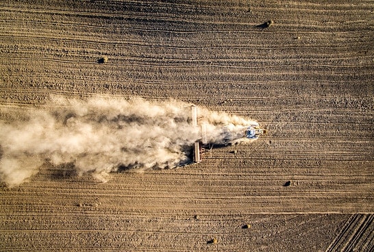 A farmer works his field during a drought