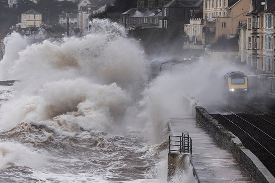 Southerly gale force winds and a high tide at Dawlish in south Devon mean that this intercity train is getting a soaking. This is also where the railway line was badly damaged February 2014