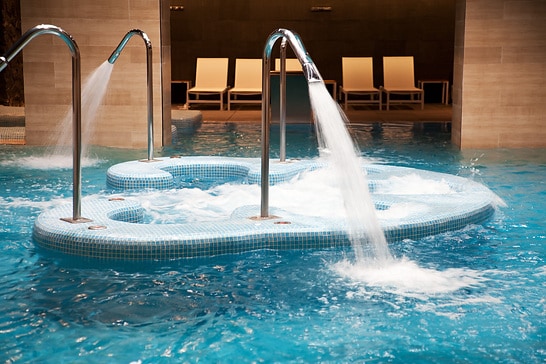 Empty indoor swimming pool with waterfall jets, whirlpools and hot tub in action. CANON EOS 5D MarkII