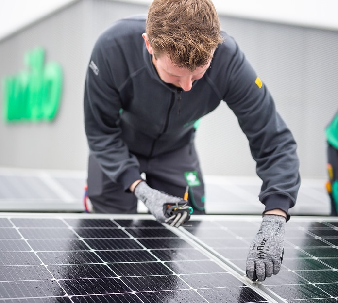 A Wilo employee at a photovoltaic system on the roof of the Smart Factory on Wilopark, the Wilo Group's headquarters in Dortmund. Wilo CEO Oliver Hermes explains: “We have, among other things, committed to reducing our absolute Scope 1 and Scope 2 emissions by 50% by 2030 and by 90% by 2050 based on figures from 2020. And we are well on our way to achieving this!” Image: WILO SE