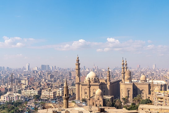 Dieses Foto wurde tagsüber von der Zitadelle von Kairo aus aufgenommen. Die Sicht ist aufgrund von Feuchtigkeit und Verschmutzung nicht klar. Die Moschee, die herausragt, ist die Sultan-Hassan-Moschee.