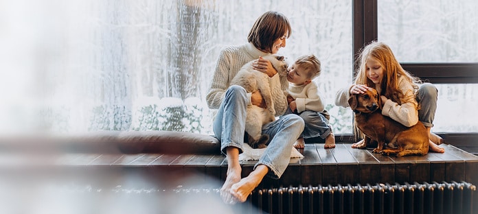 family sitting on the heater. It's cold outside and nice and warm insidefamily sitting on the heater. It's cold outside and nice and warm inside