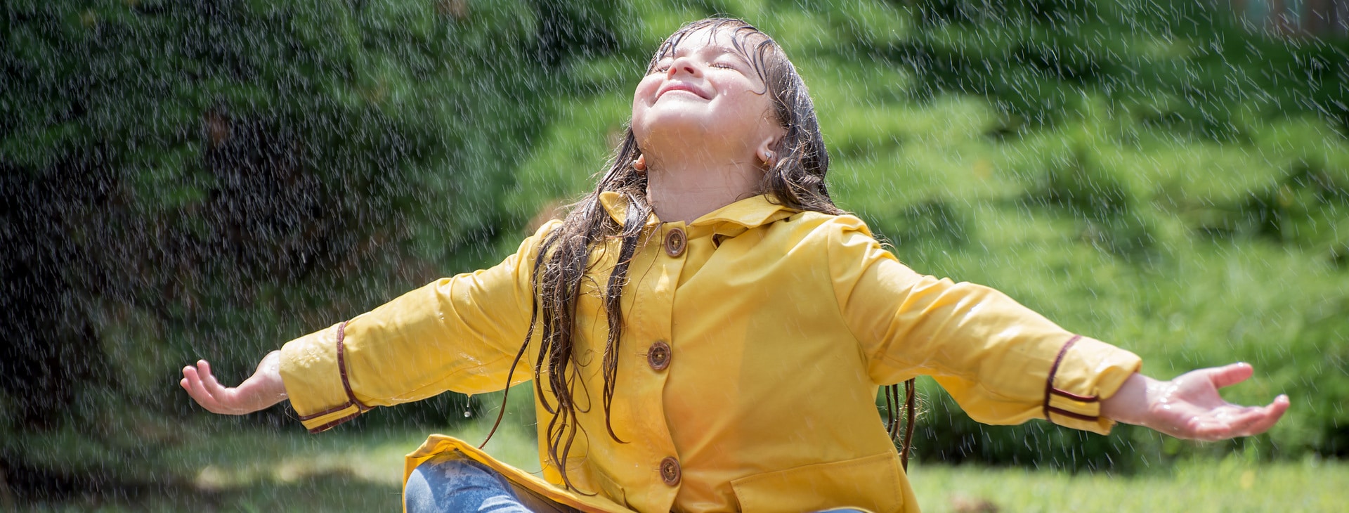 Child sitting in the rain