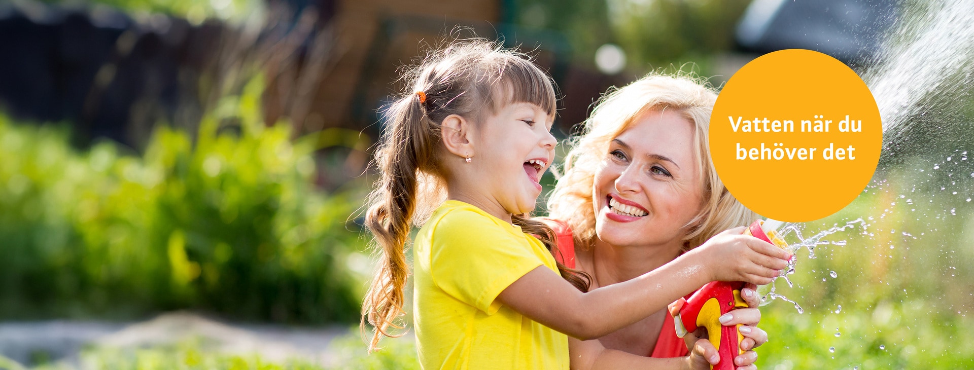Happy mother and child daughter water in domestic garden