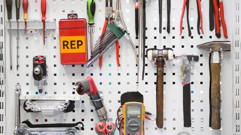 Tools on the wall in the Repair Department, hammer, screwdriver, combination wrench