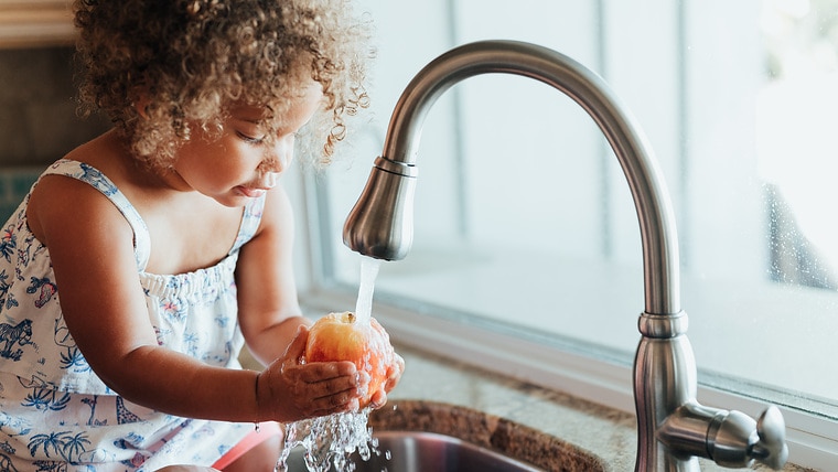 Mother and mixed race toddler daughter at home
