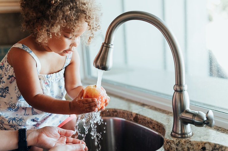 Mother and mixed race toddler daughter at home