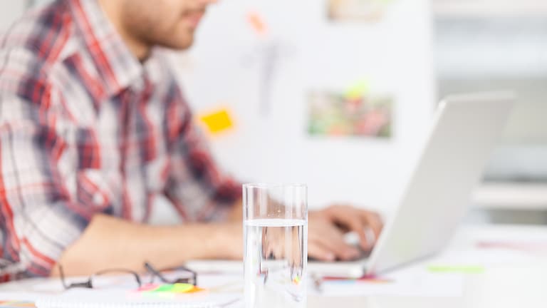 Glass of water in the office symbolizes hygienic drinking water in building technology