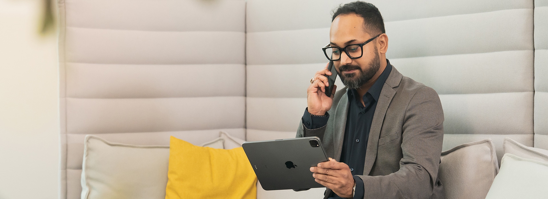 Wilo employee with an tablet and on his phone