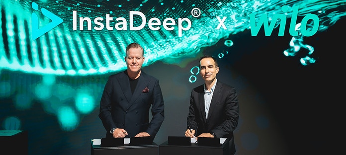 Oliver Hermes, President & Global CEO of the Wilo Group (left), and Karim Beguir, CEO and Co Founder of InstaDeep, during the signing of the partnership agreement in the Networking Cube at Wilopark.