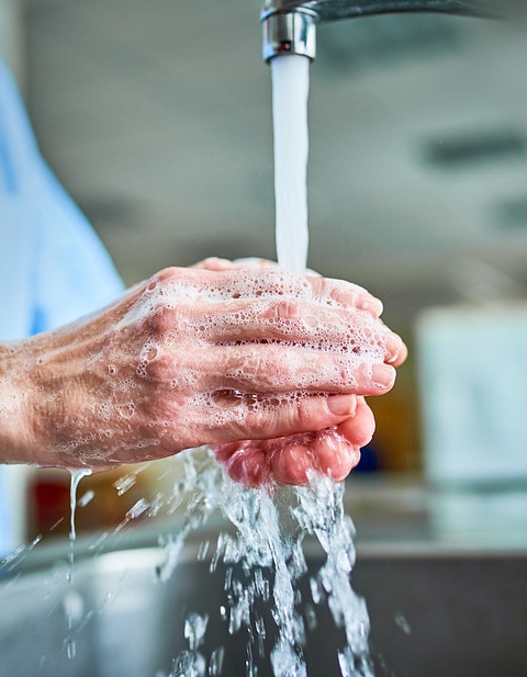 someone washing the hands in a hospital