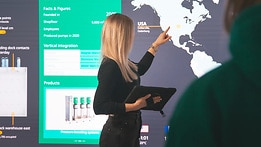 Wilo employee in front of a LED wall